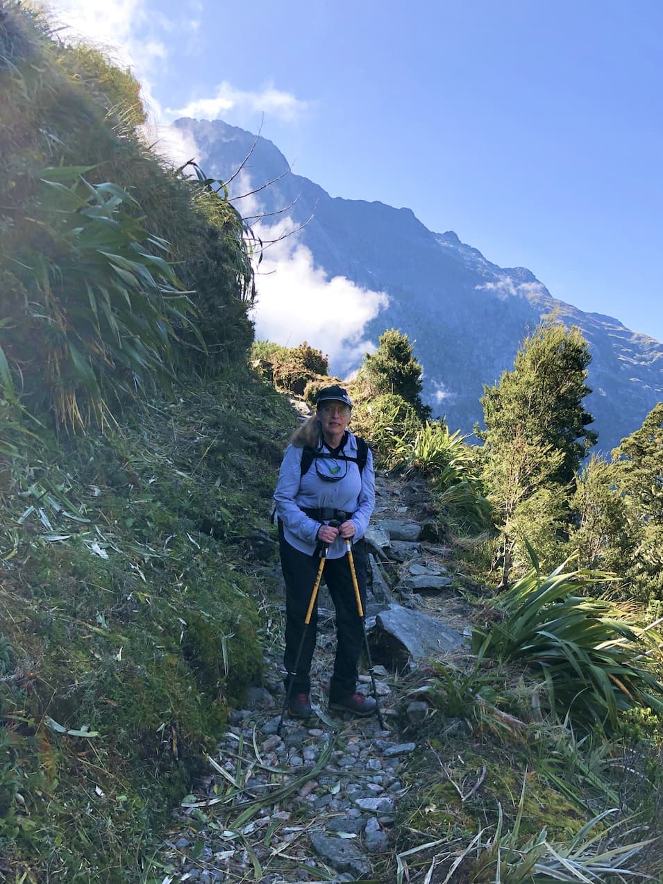 Margery hiking among the clouds on one of NZ's Great Walks.